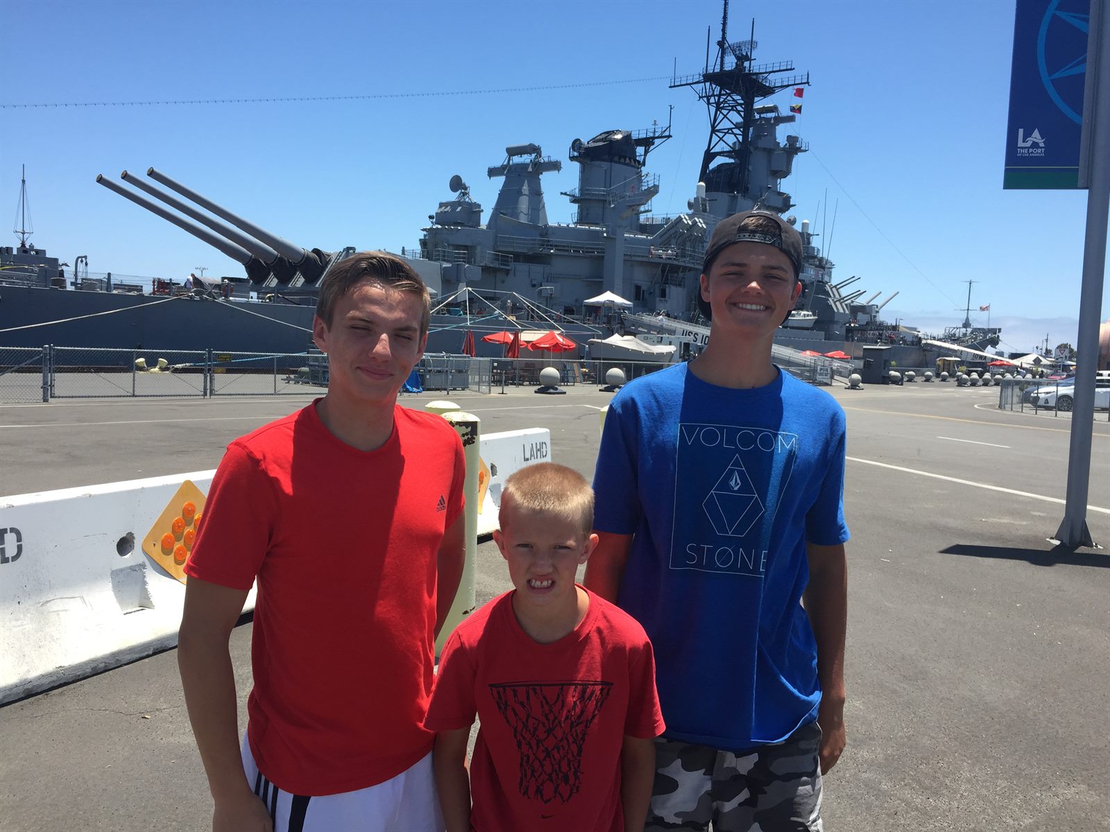 Three brothers in front of the battleship USS Iowa