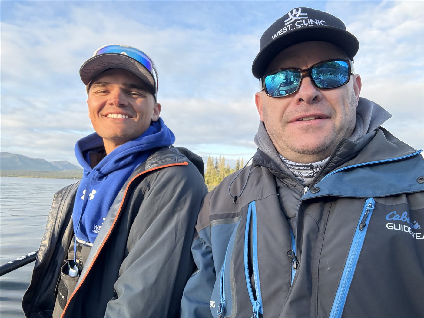 Caden and his dad in a selfie on a fishing boat