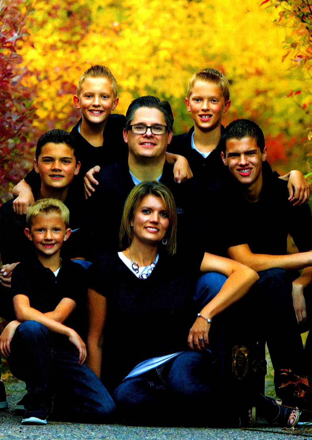 The West family of seven in navy against bright autumn foliage