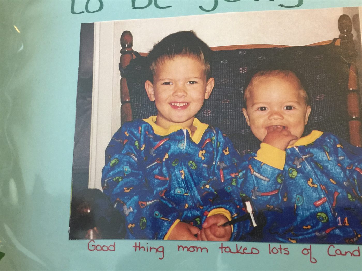 Two young brothers in matching blue tool-print pajamas